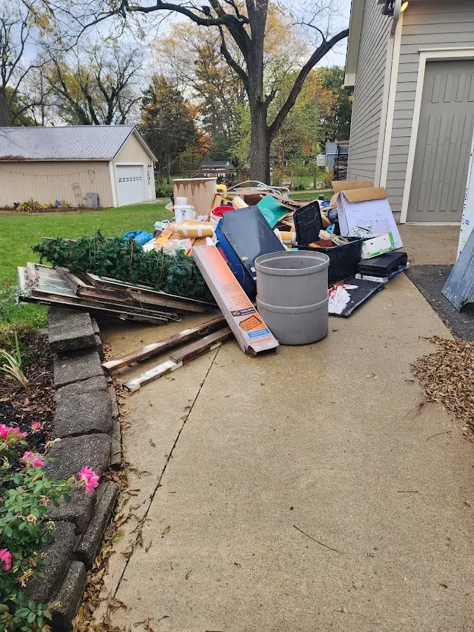 Dumpster being loaded with debris for 12 Yard Dumpster Rental in Walla Walla